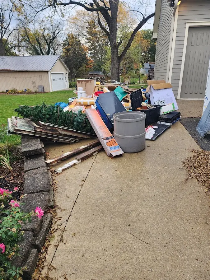 Dumpster being loaded with debris for Estate Cleanout Dumpster Rental in East Lake-Orient Park